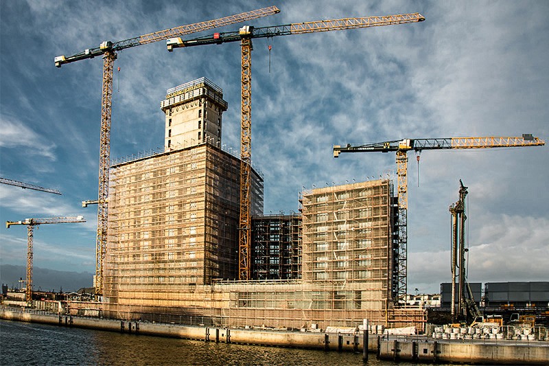 Three Liebherr tower cranes in action in Hamburg's HafenCity area