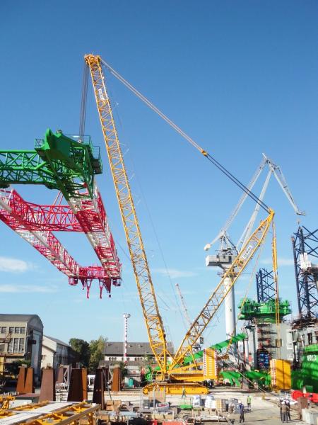 Demag CC 3800-1 Lattice Boom Crawler Crane lifts ship crane components at Shipyard facilities in Pula
