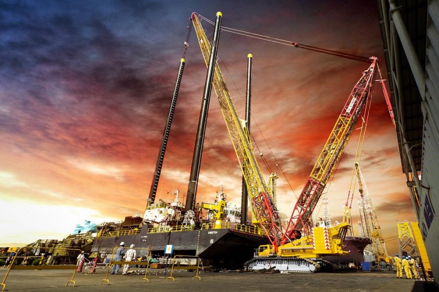 Demag CC 3800-1 lattice boom crawler crane lifts SPUD lEGS from Barge